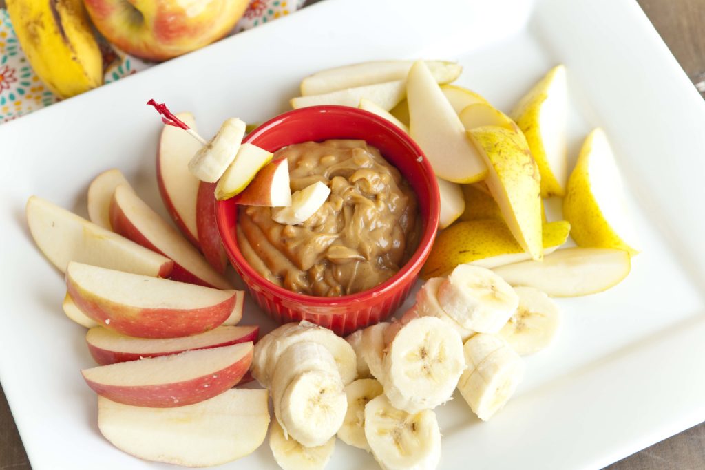 Healthy peanut butter dip with apples, pears and bananas