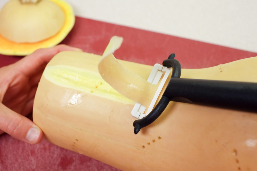 After chopping the ends off, peel the squash skin (including the green stripes underneath).